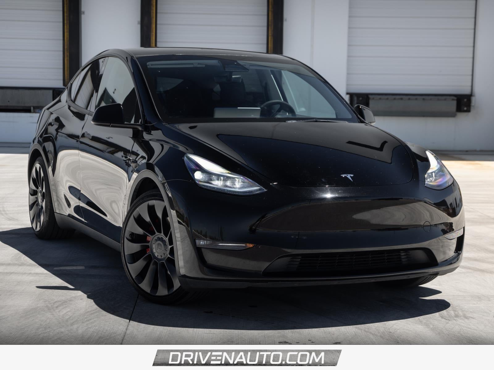 2023 Tesla Model Y Performance in Solid Black — front three-quarter view